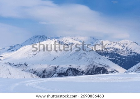 Winter view of the Caucasus Range in Gudauri, Georgia. Aerial view of snow-covered ski slopes at the Gudauri ski resort.