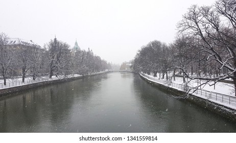 Winter View Of The Isar River On The Ludwigsbrücke Bridge In Munich, Germany