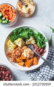 Winter Warm Vegan Buddha Bowl With Beans, Baked Vegetables, Tofu, Hummus And Beans.