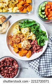 Winter Warm Vegan Buddha Bowl With Beans, Baked Vegetables, Tofu, Hummus And Beans.