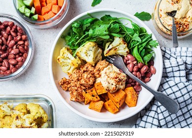 Winter Warm Vegan Buddha Bowl With Beans, Baked Vegetables, Tofu, Hummus And Beans.