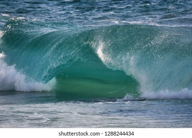 Winter Waves In Porthcurno, Cornwall. Waves Crashing On The Rocks And Beach