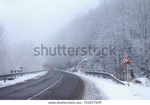 Winter weather, snow on the\
road. Snow calamity on the road. Snowstorm in Slovakia, mountain\
pass .