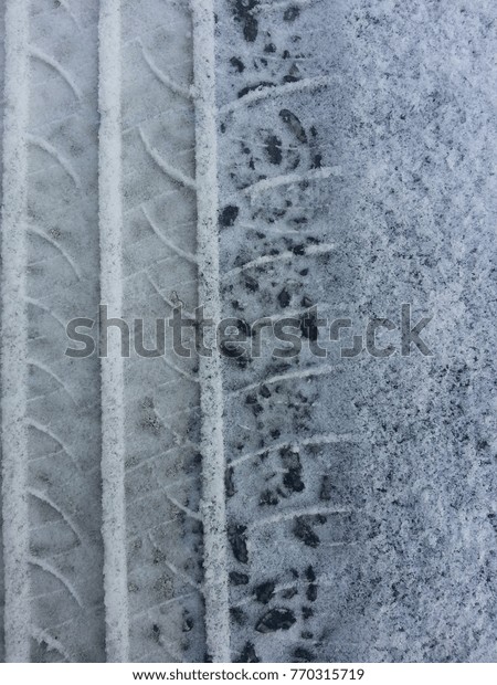 Winter weather, snow on the road with imprints of\
car tires