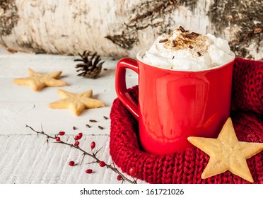 Winter whipped cream hot coffee in a red mug with star shaped cookies and warm scarf - rural still life - Powered by Shutterstock