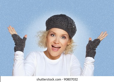 Winter woman / Beautiful blond mid adult woman enjoys the snowfall