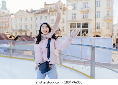 Winter Woman Happy Outside In Snow Smiling Joyful On Snowing Winter Day. Cute Beautiful Mixed Race Caucasian Asian Girl With Flying Scarf To Skate On The Rink Cheerful And Excited Outdoors.