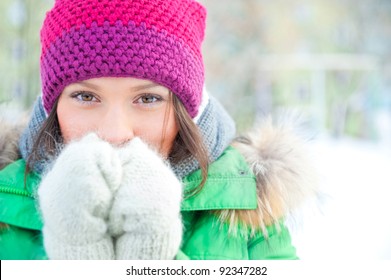 Winter Woman In Snow Looking At Camera Outside On Snowing Cold Winter Day. Portrait Caucasian Female Model Outside In First Snow