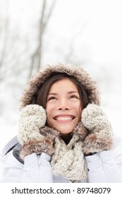 Winter Woman In Snow Looking Up At Copy Space Outside On Snowing Cold Winter Day. Portrait Multiethnic Caucasian Asian Female Model Outside In First Snow