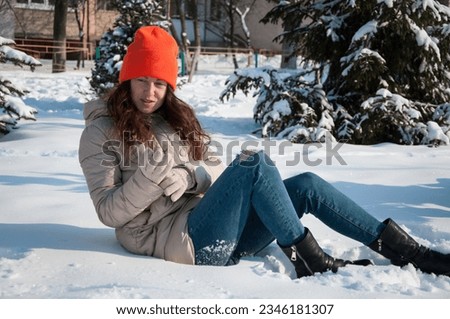 winter woman in warm hat sit in snow wintertime. winter fashion of woman in warm hat with wintertime snow.