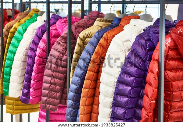 Winter women\'s\
jackets on a hanger in the\
store