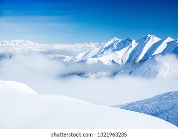 Winter wonder land with a ski park - a beautiful mountain landscape with a amazing blue sky. The sun is shining and the hills are covered with snow like the alps, himalaya ore the rockymountains