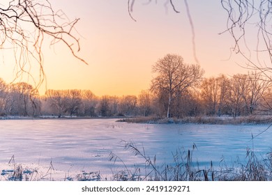 Winter wonderland. Frozen river framed of snow-covered trees, hoarfrost on branches. Clear sunrise blue sky. Idyllic landscape. Nature seasons climate change, ecology, ecotourism. Christmas vacations - Powered by Shutterstock