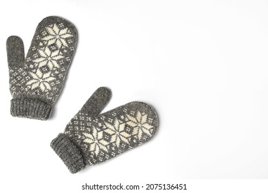 Winter woolen mittens with a pattern isolated on a white background. Winter accessory. Flat lay, top view.