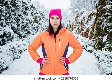 Winter Workout, Exercising In Cold Weather. Winter Fitness, Safety Tips For Exercising Outdoors. Sporty Woman In Sportswear Standing In Winter Snowy Park, Forest.