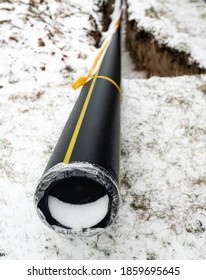 Winter Works On The Construction Of A Natural Gas Pipeline. A Frozen Trench Dug In The Ground. Bad Weather And Suspension Of Work.