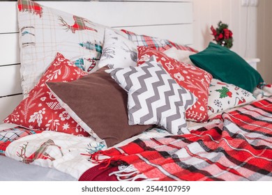 Winter Xmas Hygge home decor. Festive cozy bedroom in Skandinavian style with bed and colorful red pillows. Concept new year and holidays. Interior design bedroom. - Powered by Shutterstock