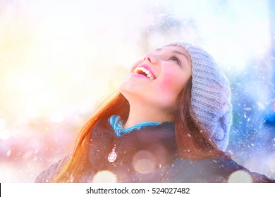 Winter Young Woman Portrait. Beauty Joyful Model Girl Raising Hands, Spinning And Laughing, Having Fun In Winter Park. Beautiful Young Woman Laughing Outdoors. Enjoying Nature, Wintertime