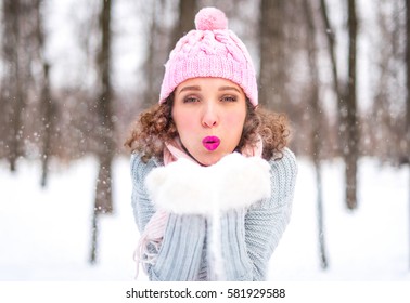 Winter young woman portrait. Beauty Joyful Model Girl having fun in winter park. Beautiful young woman laughing outdoors. Enjoying nature, wintertime