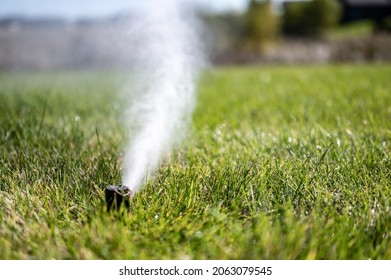 winterizing a irrigation sprinkler system by blowing pressurized air through to clear out water - Shutterstock ID 2063079545