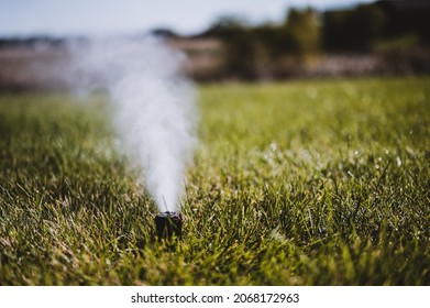 winterizing a irrigation sprinkler system by blowing pressurized air through to clear out water - Shutterstock ID 2068172963