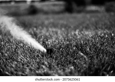 winterizing a irrigation sprinkler system by blowing pressurized air through to clear out water - Shutterstock ID 2073625061