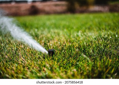 winterizing a irrigation sprinkler system by blowing pressurized air through to clear out water - Shutterstock ID 2075856418