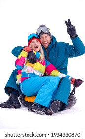 Wintersport Activities. Lovely Caucasian Couple Having Tube Activities In Winter Time And Posing Together And Laughing Outdoor. Vertical Image