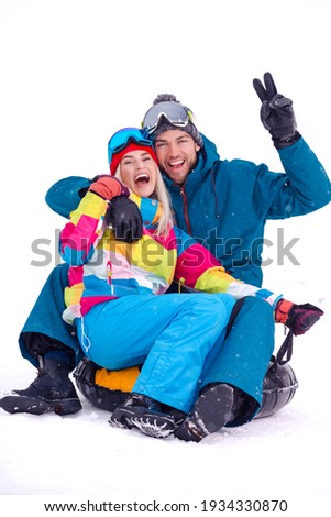 Wintersport Activities. Lovely Caucasian Couple Having Tube Activities In Winter Time And Posing Together And Laughing Outdoor. Vertical Image