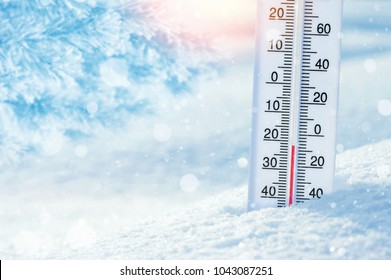 Wintertime. Winter background with  thermometer in the snow on frosty day.