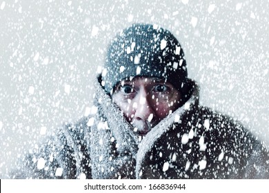 Wintery scene of shivering man in snowstorm or ice storm 