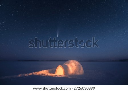 Wintry scene with snowy igloo and starry night sky. Fantastic winter landscape glowing by star light. Santa house from snow, ideal New Year and Christmas background