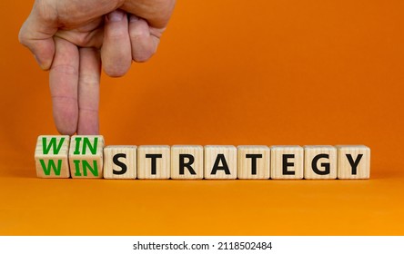 Win-win Strategy Symbol. Businessman Turns Wooden Cubes With Words Win Win Strategy. Beautiful Orange Table, Orange Background. Business, Win-win Strategy Concept. Copy Space.