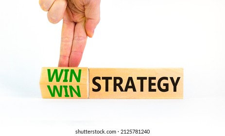 Win-win Strategy Symbol. Businessman Turns Wooden Cubes With Words Win Win Strategy. Beautiful White Table, White Background. Business, Win-win Strategy Concept. Copy Space.