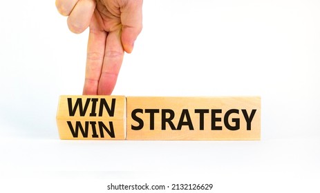 Win-win Strategy Symbol. Businessman Turns Wooden Cubes With Words Win Win Strategy. Beautiful White Table, White Background. Business, Win-win Strategy Concept. Copy Space.