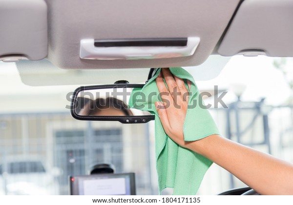 Wipe and clean the car\
rearview mirror
