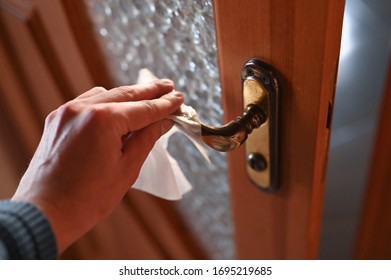 Wipe The Dirty Doorknob With An Antibacterial Wipe. The Concept Of Coronavirus.