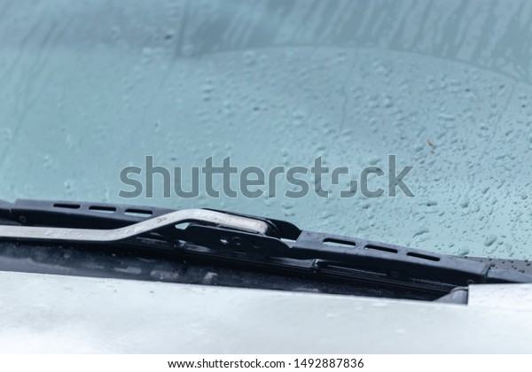 The\
wiper blade is located at the front glass of the\
car.