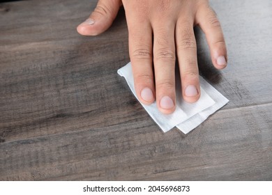 wipes the table with a napkin - Shutterstock ID 2045696873