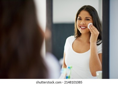 Wiping Away Impurities. Shot Of An Attractive Young Woman Getting Ready In Her Bathroom.