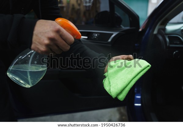 Wiping dust\
in car. Car cleaning. Wet car\
cleaning