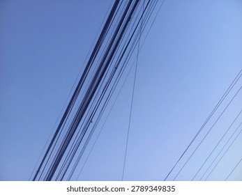 Wire assemblage a lot of cables and wires on pole. blue sky background. 