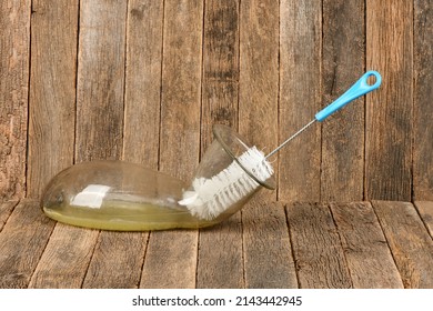 Wire Brush For Cleaning Bottles Isolated On Dark Wood Background. Brush  Inside Small Empty Glass Bottle. High Resolution Photo. Full Depth Of Field. 