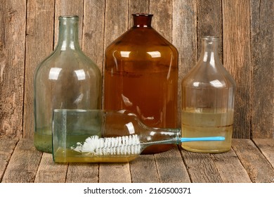 Wire Brush For Cleaning Bottles Isolated On Dark Wood Background. Brush  Inside Small Empty Glass Bottle. High Resolution Photo. Full Depth Of Field. 