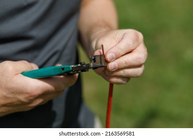 A Wire Cutter In A Man's Hands, Cutting Electrical Wire