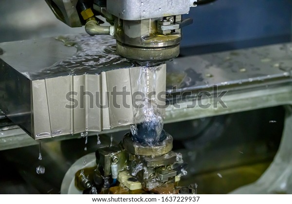 The  Wire EDM machine cutting the die parts\
with liquid coolant. The mold and die manufacturing process by wire\
cut machine control by CNC\
program.