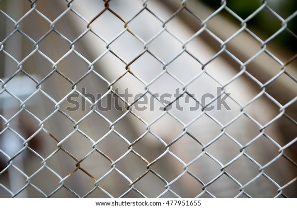 A wire\
fence on side of bridge to protect people from falling down on the\
railway below, in Nacka, Sweden in\
August.