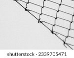 Wire fence shadow on a wall, black and white tones. Abstract background, copy space for text 