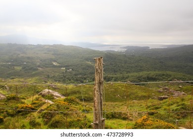 Wire Fence And Wooden Post With Rocky Irish Terrain