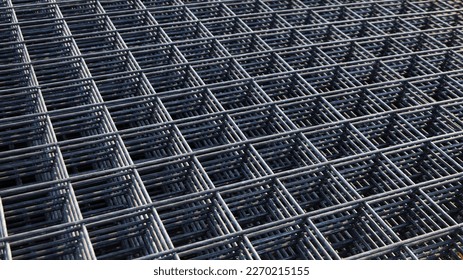 Wire mesh piles for construction. BRC welded steel wire mesh for concrete slab reinforcement of construction construction site in top view with natural light and selective focus.